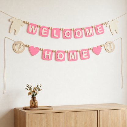 Pink WELCOME HOME felt garland with baby bodysuit shapes, footprints and hearts