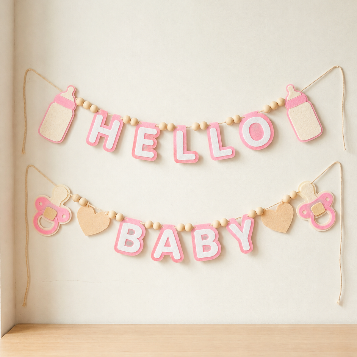 Pink HELLO BABY felt garland with baby bottle shapes, pacifiers and hearts