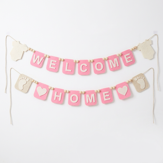 Pink WELCOME HOME felt garland with baby bodysuit shapes, footprints and hearts